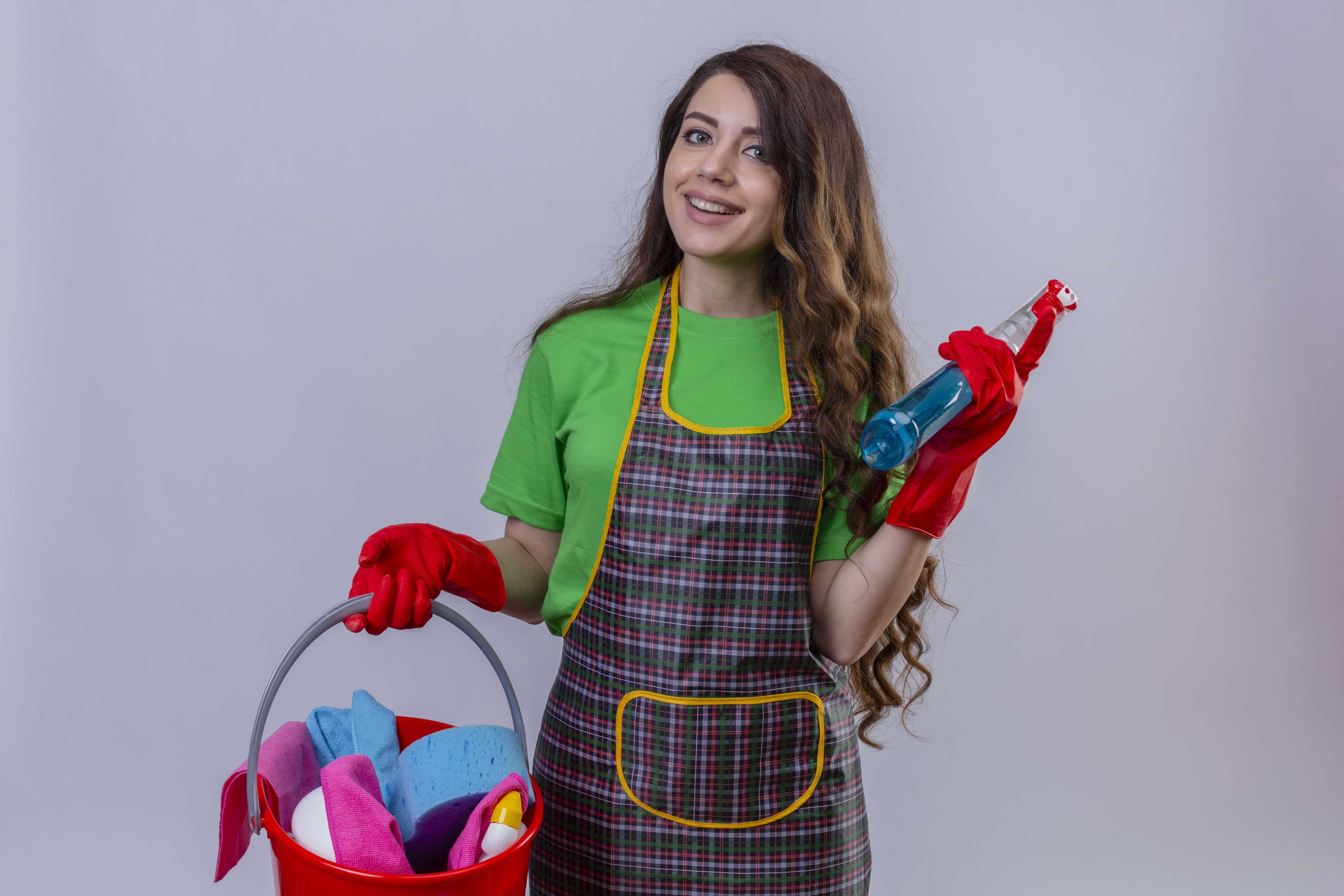 <span  class="uc_style_uc_tiles_grid_image_elementor_uc_items_attribute_title" style="color:#ffffff;">young beautiful woman with long wavy hair wearing apron and rubber gloves holding bucket with cleaning supplies and spray looking at camera with happy face smiling over white background</span>